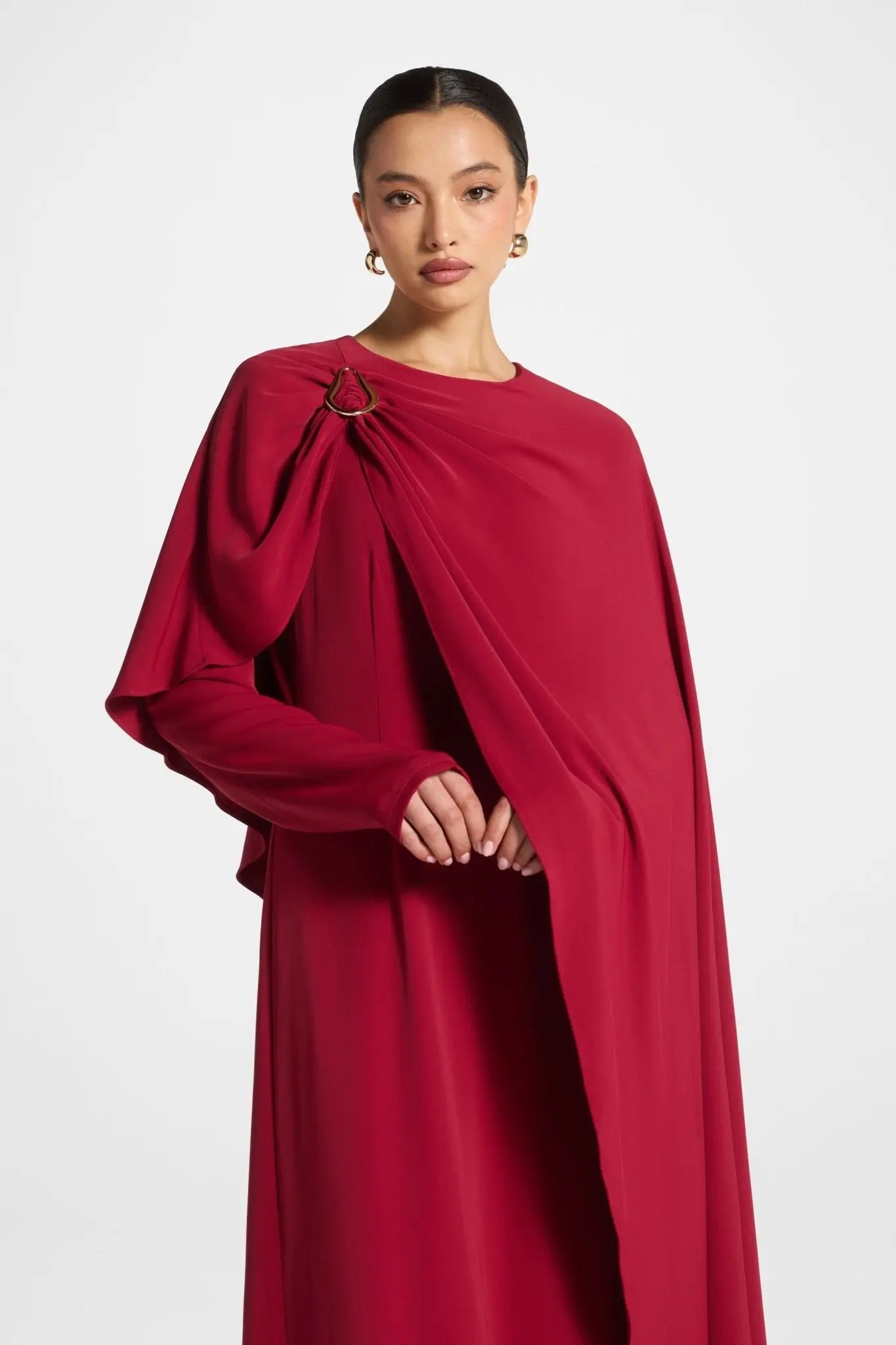 Red evening gown with a large bow detail on a white background