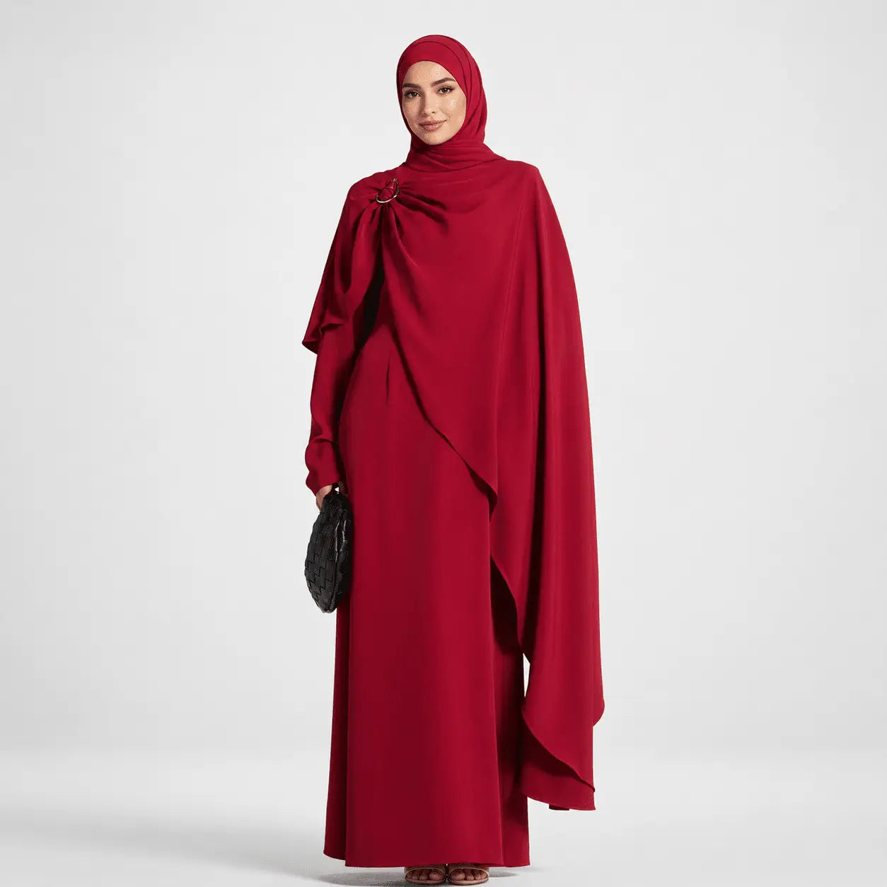 Woman wearing a red abaya on a white background