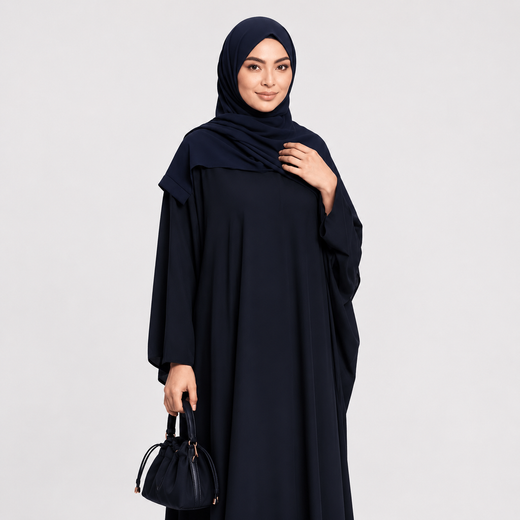 Woman wearing a black abaya and hijab on a light gray background