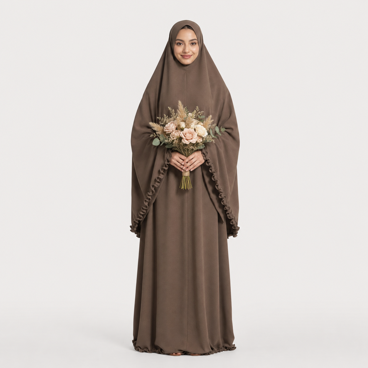Woman wearing a brown abaya holding a bouquet of flowers on a white background