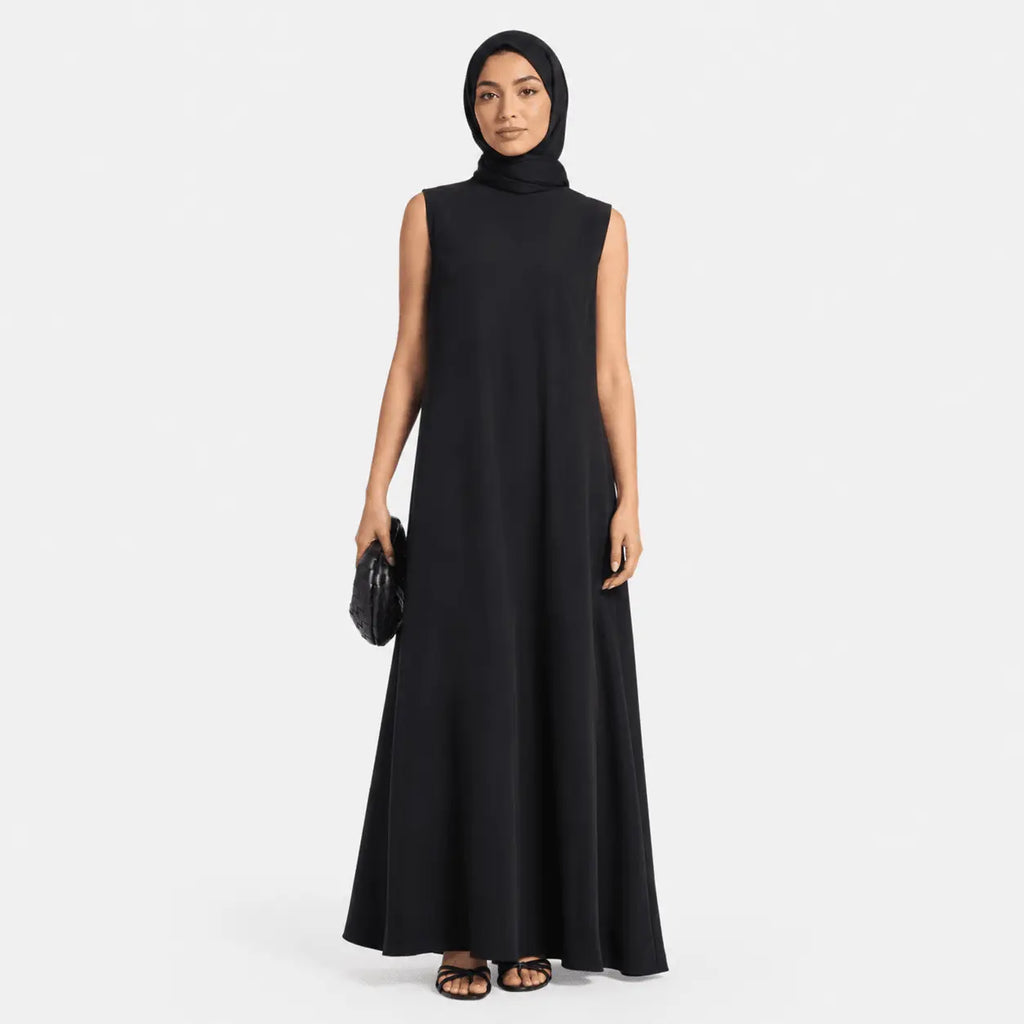 Woman wearing a black sleeveless dress on a white background
