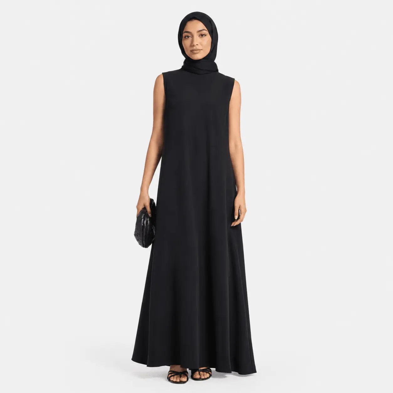 Woman wearing a black sleeveless dress on a white background