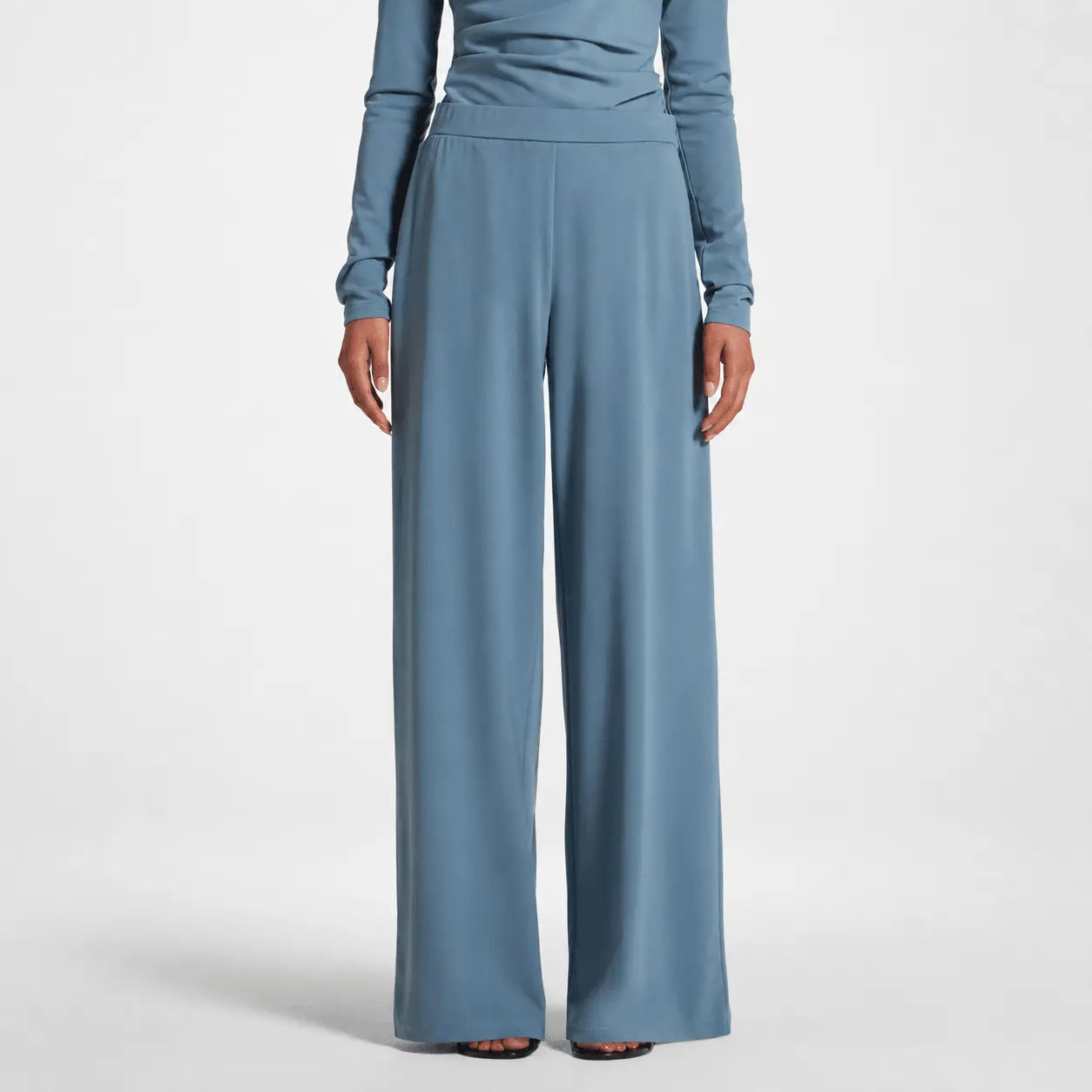 Blue long-sleeve top and wide-leg pants on a white background