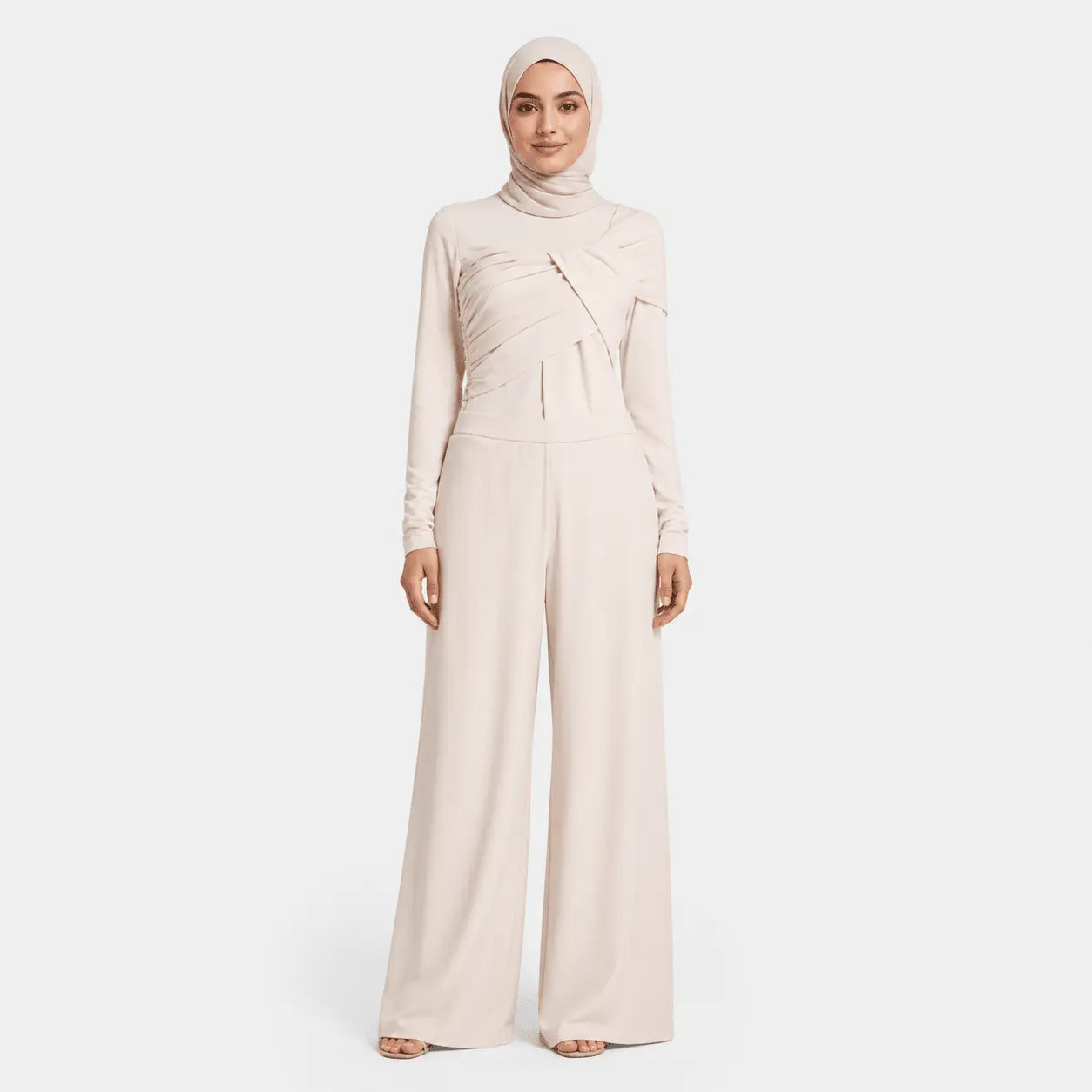 Woman wearing a beige jumpsuit and hijab on a white background