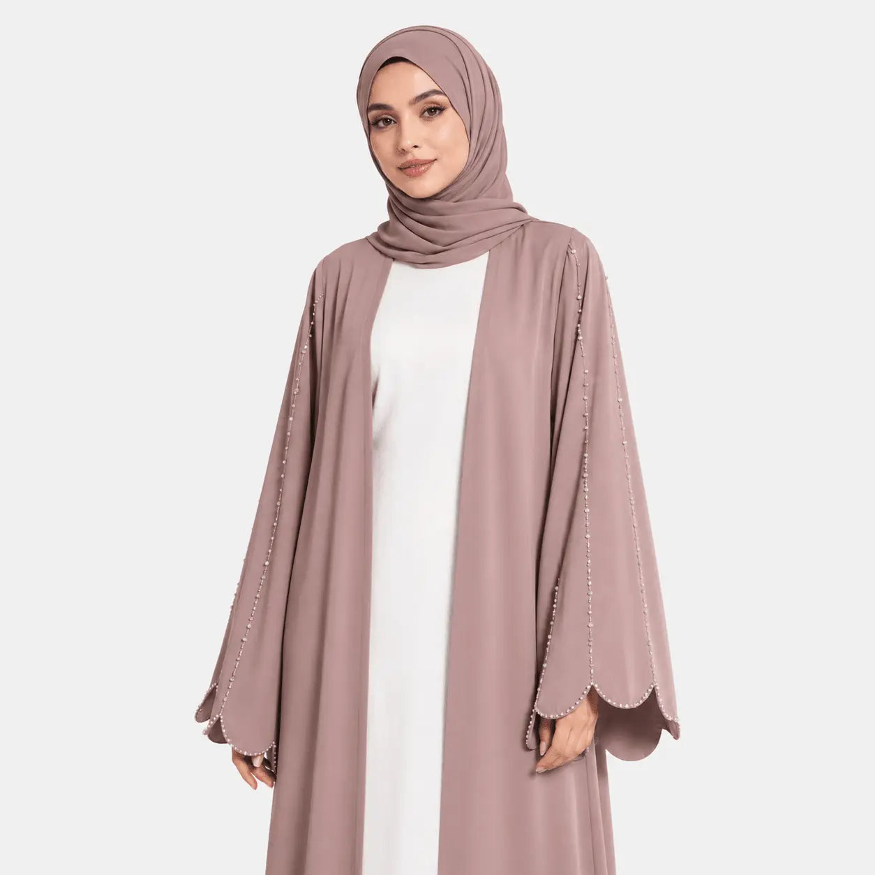 Woman wearing a mauve abaya with embellishments on a white background
