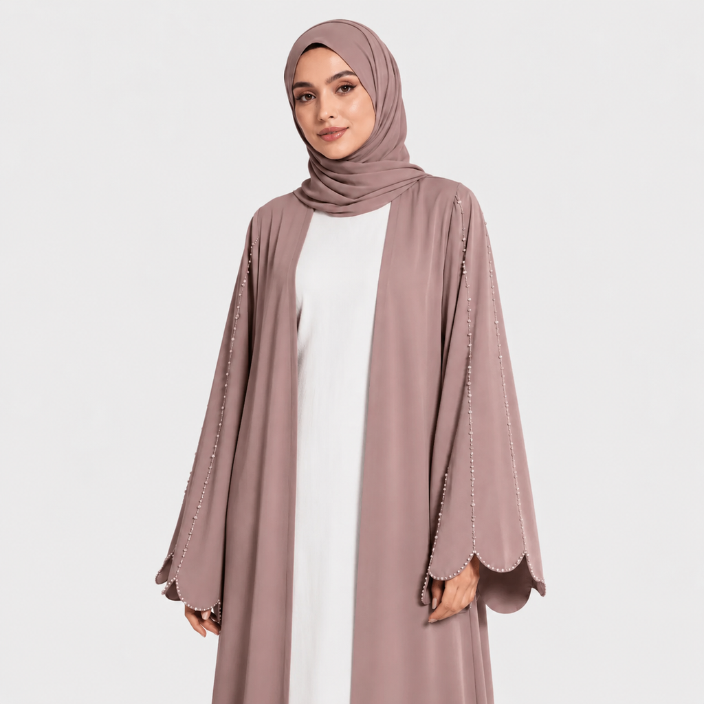 Woman wearing a long mauve cardigan over a white dress on a white background