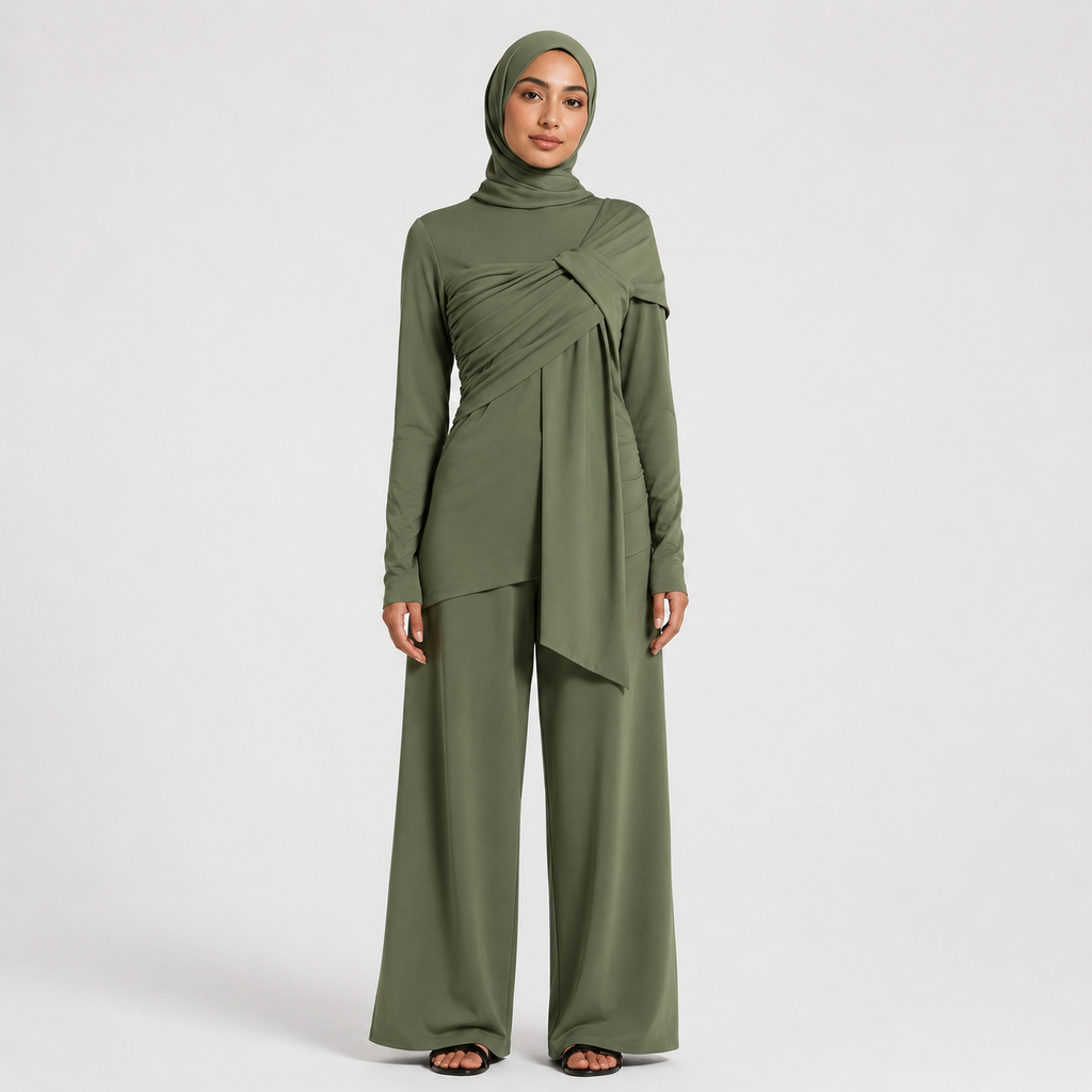 Woman wearing a green outfit with a hijab on a white background
