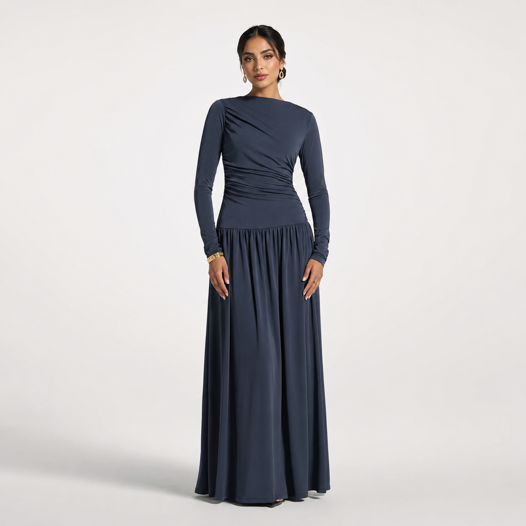 Woman wearing a long navy dress on a light gray background