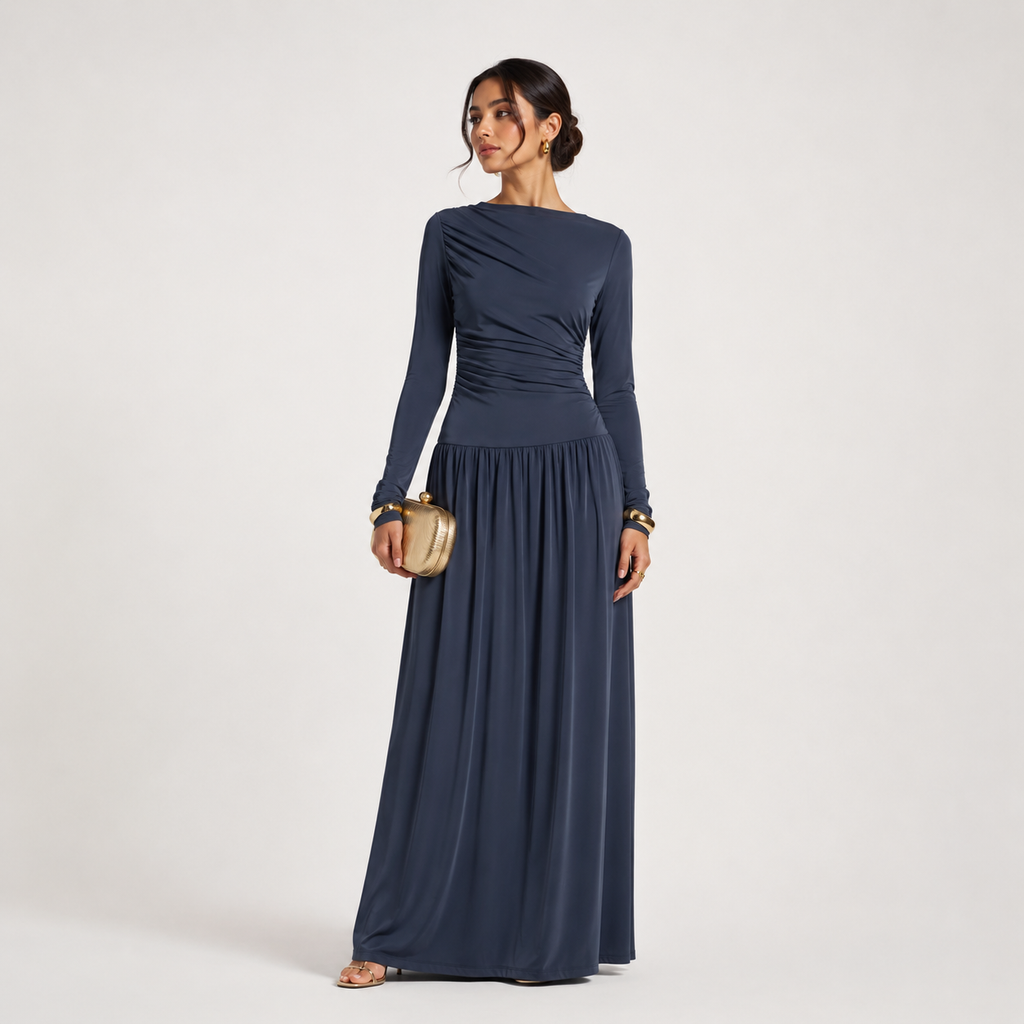 Woman wearing a long navy dress on a light gray background