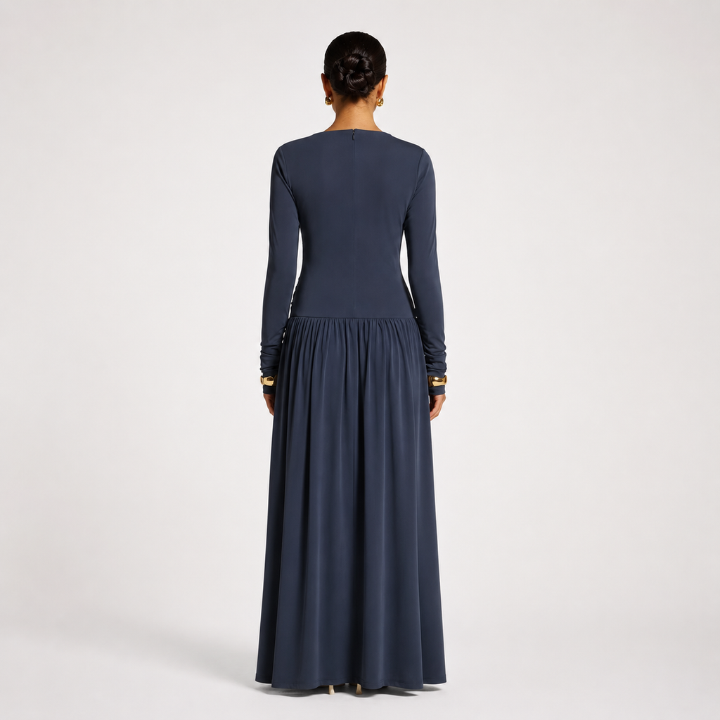 Woman wearing a long dark blue dress on a white background