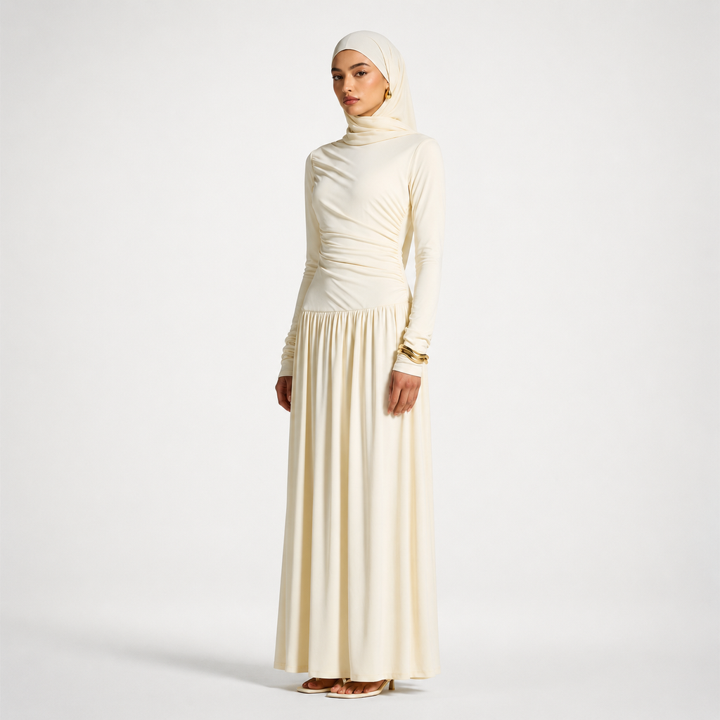 Woman wearing a long, light-colored dress with a hijab on a white background