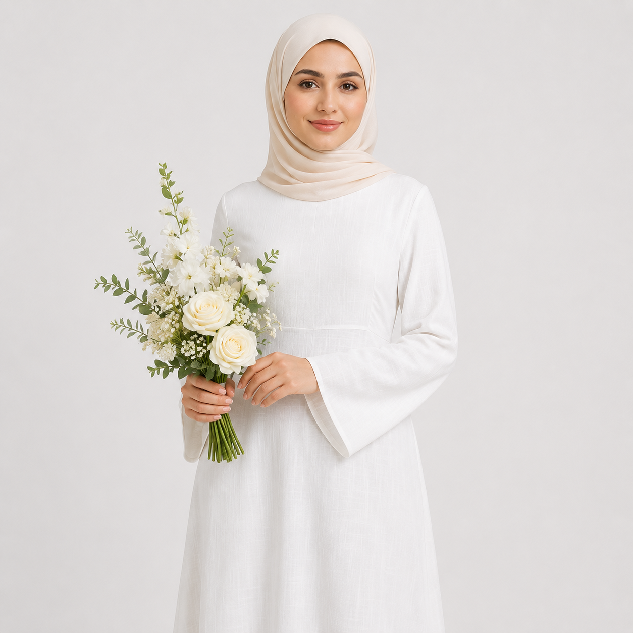 White modest abaya dress styled with beige hijab, floral bouquet, and cream handbag on a clean studio background
