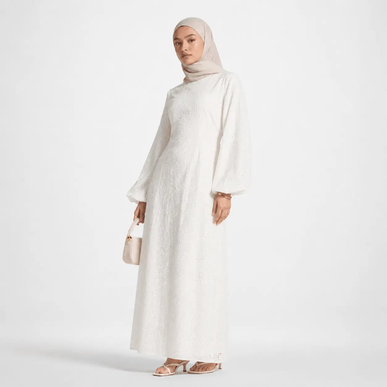 White lace modest dress with long sleeves, hijab, and heels for elegant Muslim fashion