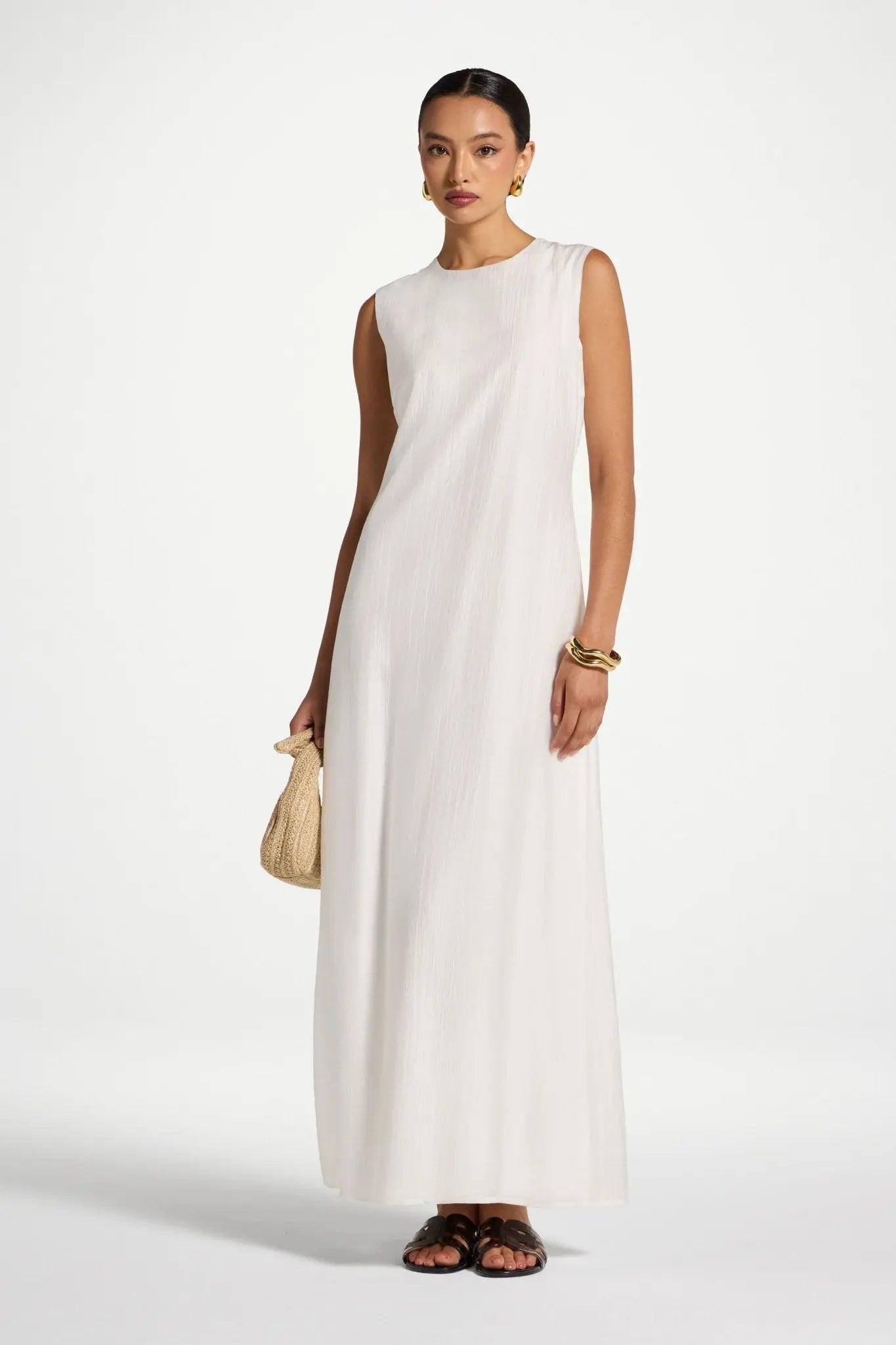 Woman wearing a white sleeveless dress on a white background