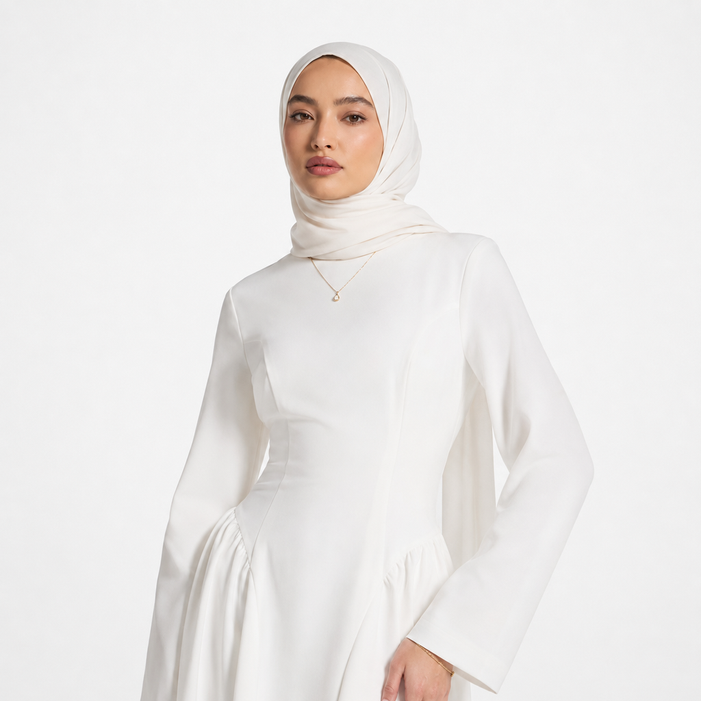 Woman wearing a white hijab and dress on a white background