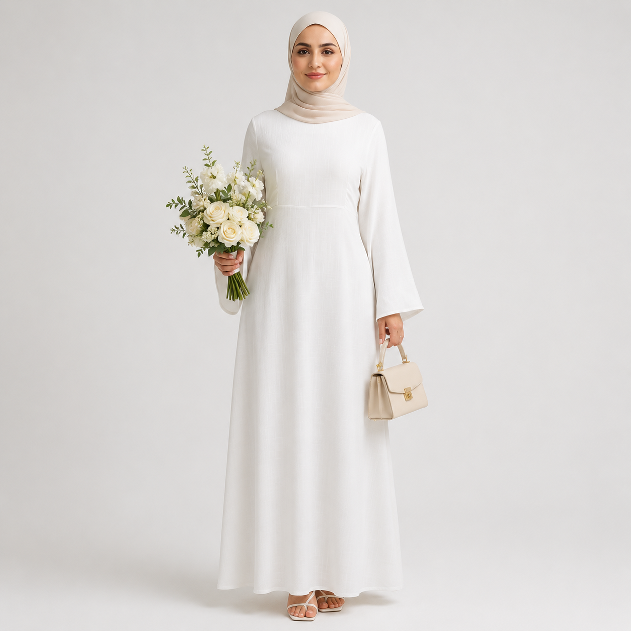 White modest abaya dress styled with beige hijab, floral bouquet, and cream handbag on a clean studio background
