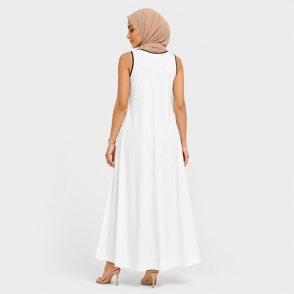 Woman wearing a white sleeveless dress and beige hijab on a plain background