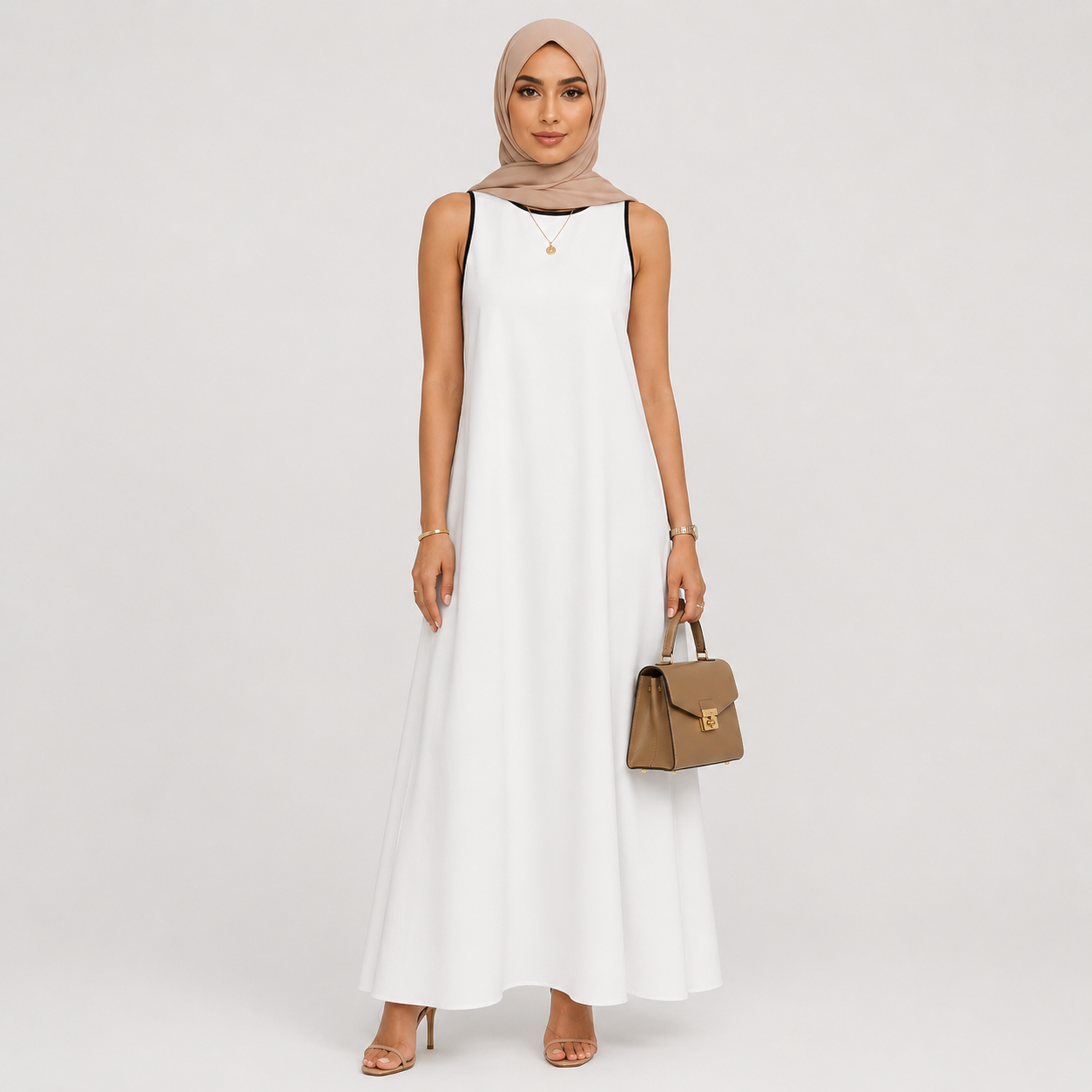 Woman wearing a white sleeveless dress and beige hijab holding a brown handbag on a white background