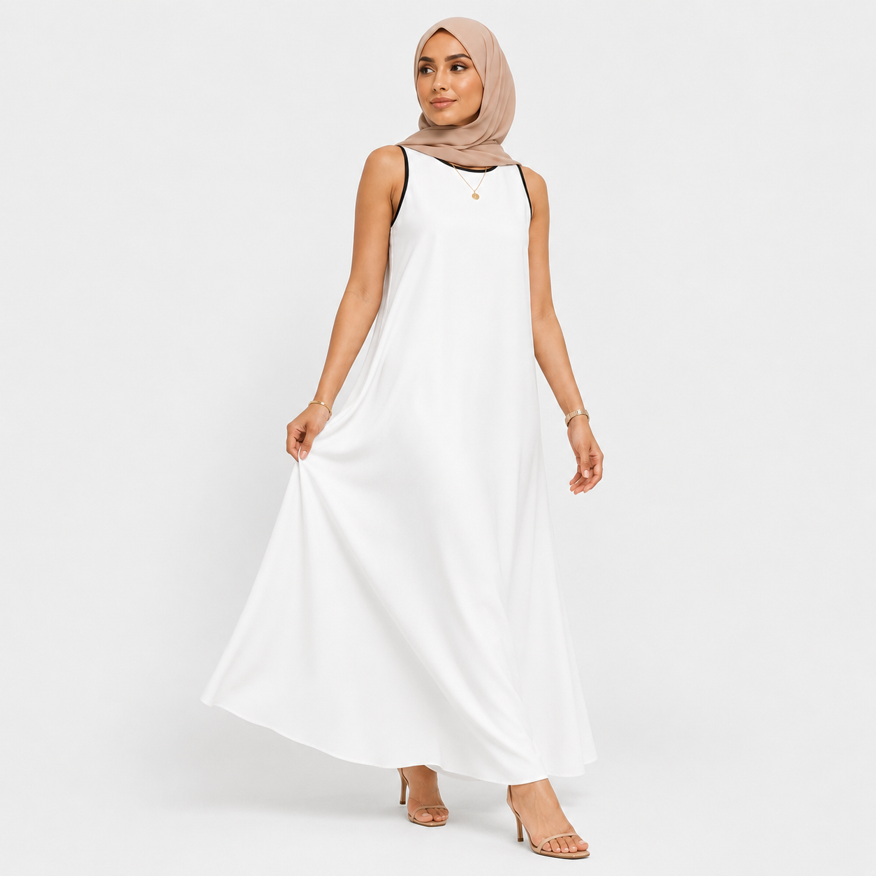 Woman wearing a white sleeveless dress on a plain background