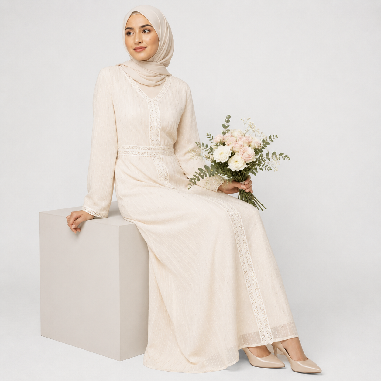 Woman in white lace modest dress with hijab, elegant long sleeves, and soft fabric texture