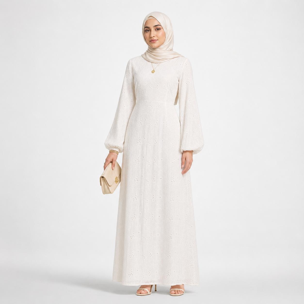 Woman wearing a long white dress and hijab on a light gray background