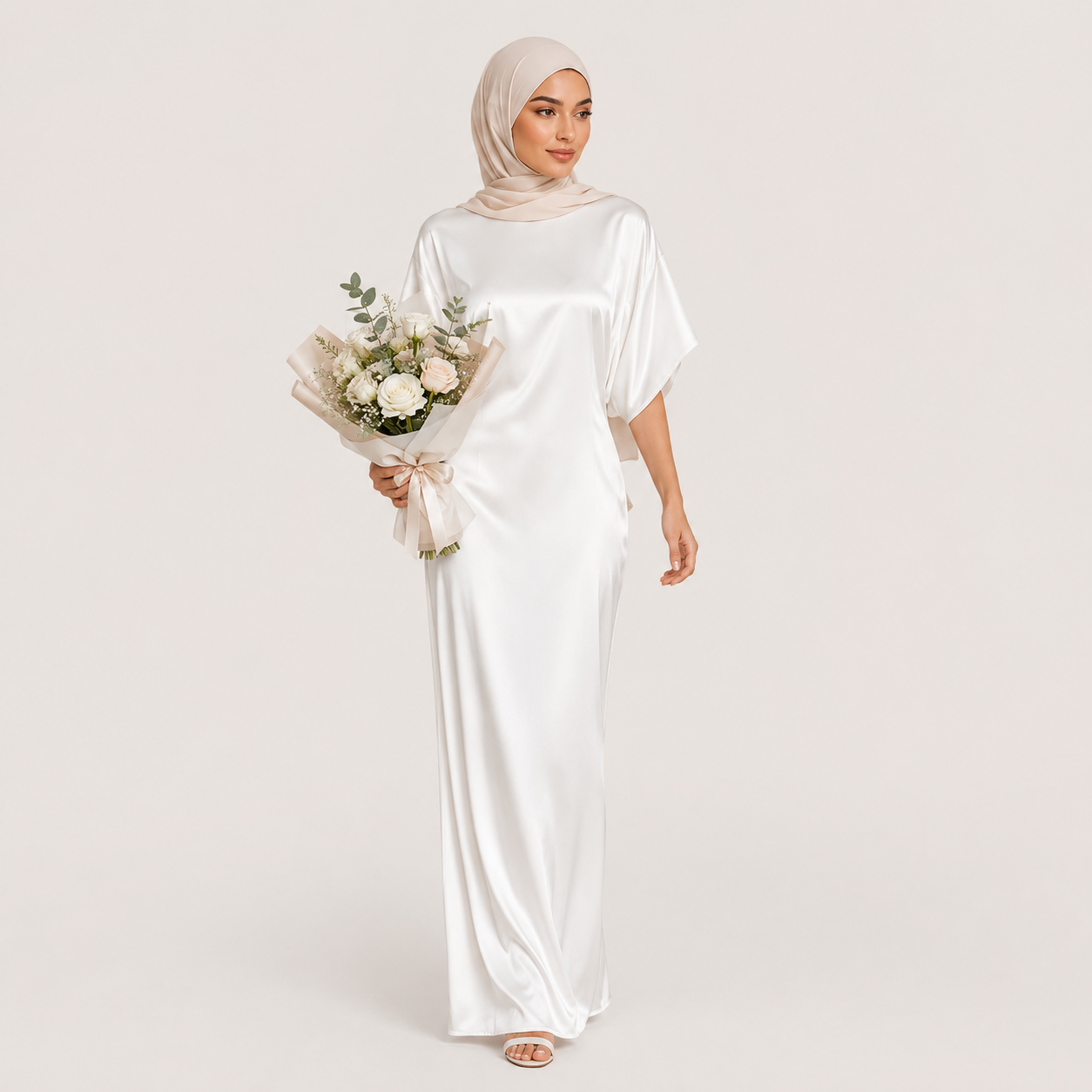 Woman in a white dress holding a bouquet of flowers on a plain background