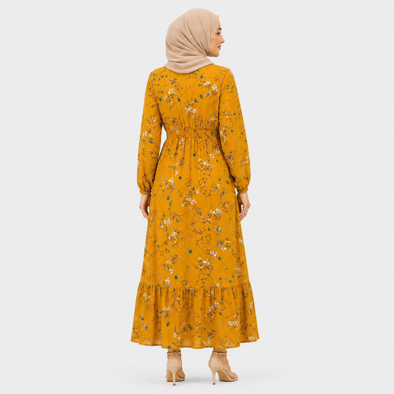 Woman wearing a mustard yellow floral dress on a white background