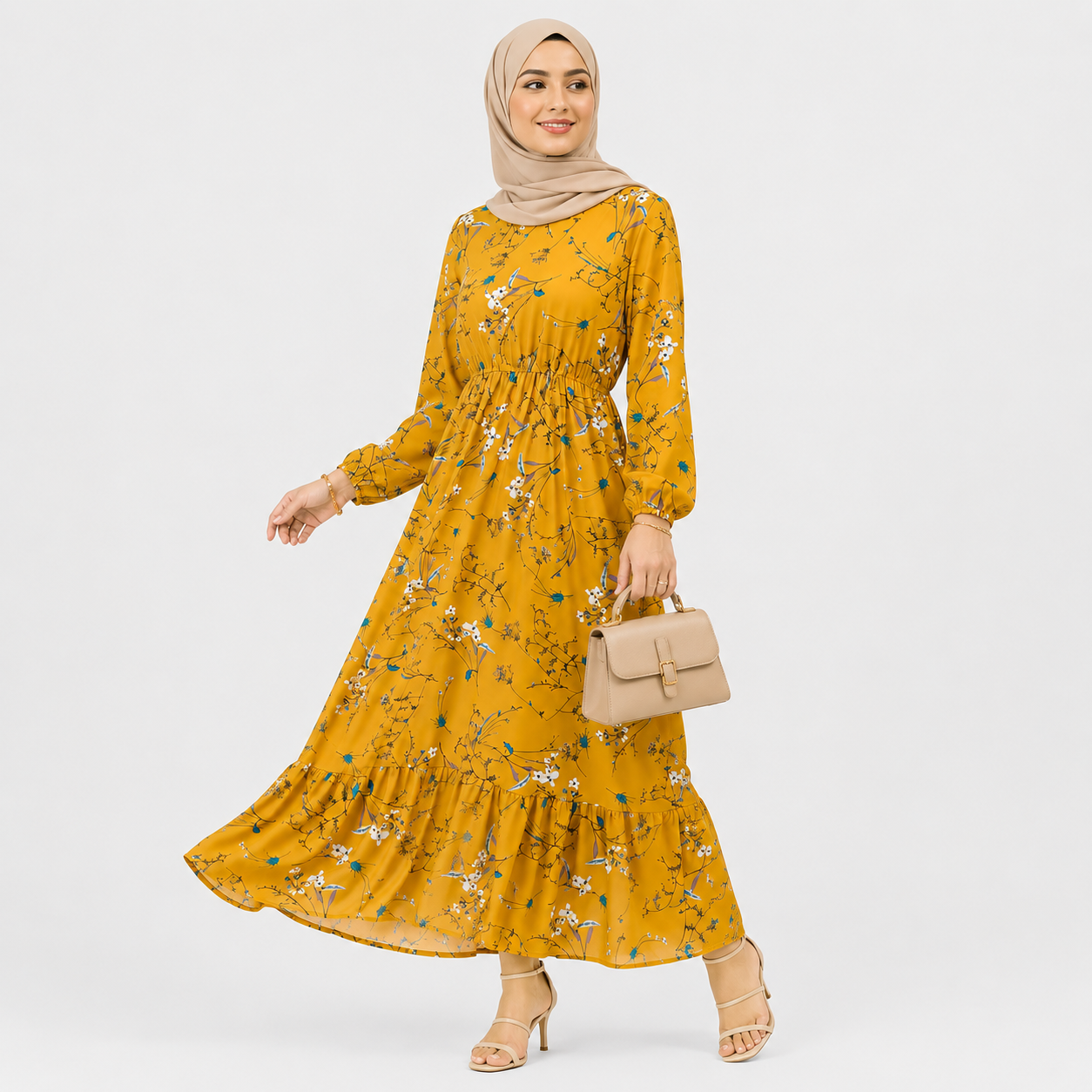 Woman wearing a yellow floral dress with a beige hijab and handbag on a white background